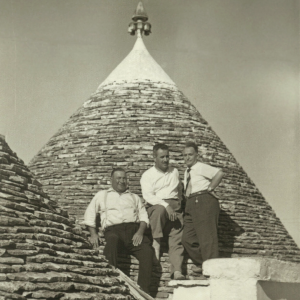 Black and white photo of three men on the roof of the Trullo